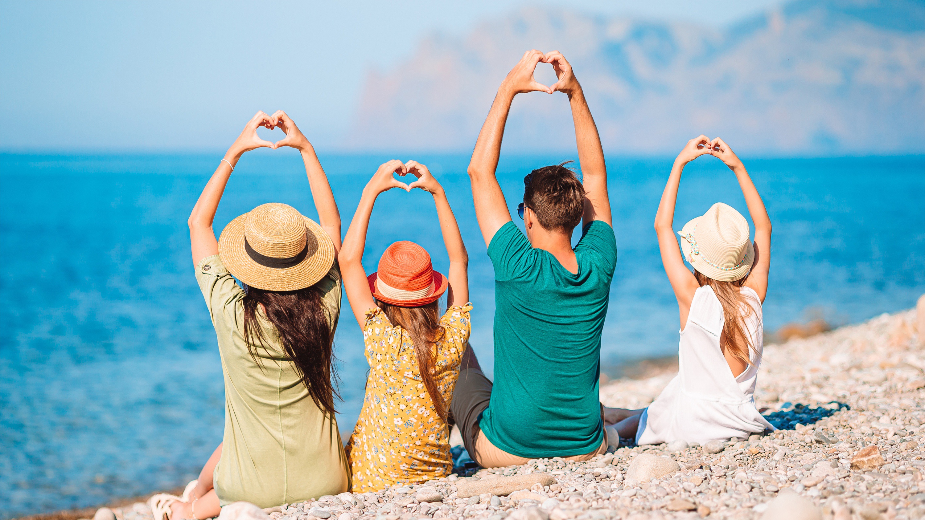 Family heart handmade at the beach